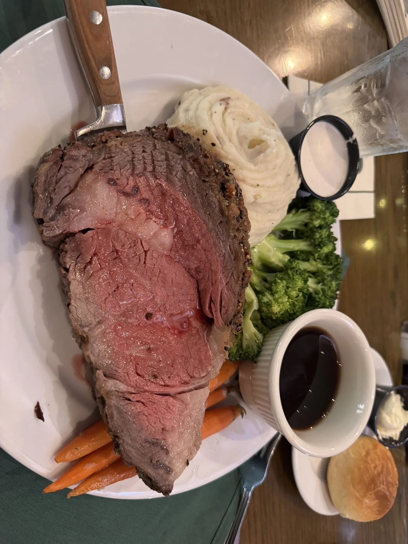 Plate of sliced roast beef with mashed potatoes, vegetables, and gravy